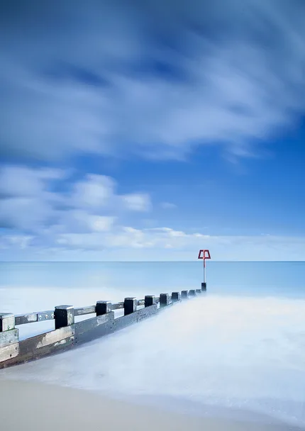 Swanage groyne with a long exposure of blue sea and sky