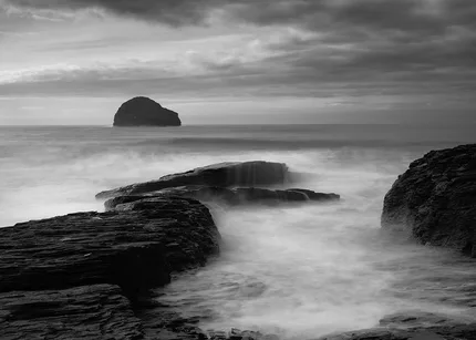 Trebarwith Strand slow motion black and white with silky water sweeping over the rocks.