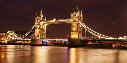 London Bridge turns golden after dark.