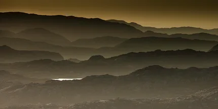 Layers of rock or mountains at dusk