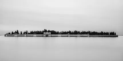 A long exposure of the water and sky around San Michele Cemetery on the dedicated island of Isola de San Michele in the Venetian lagoon