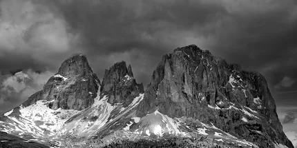 a black and white image of Three mountain peaks in the Dolomites
