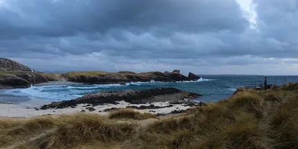 Dark clouds over a small bay of Clachtoll.
