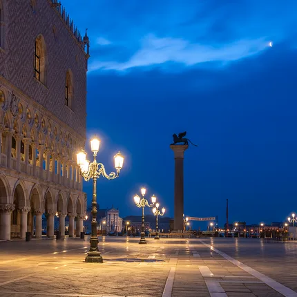 Doge's Palace during blue hour. Iconic Venetian lamps
